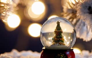 A glass Christmas snowball with Christmas tree inside.